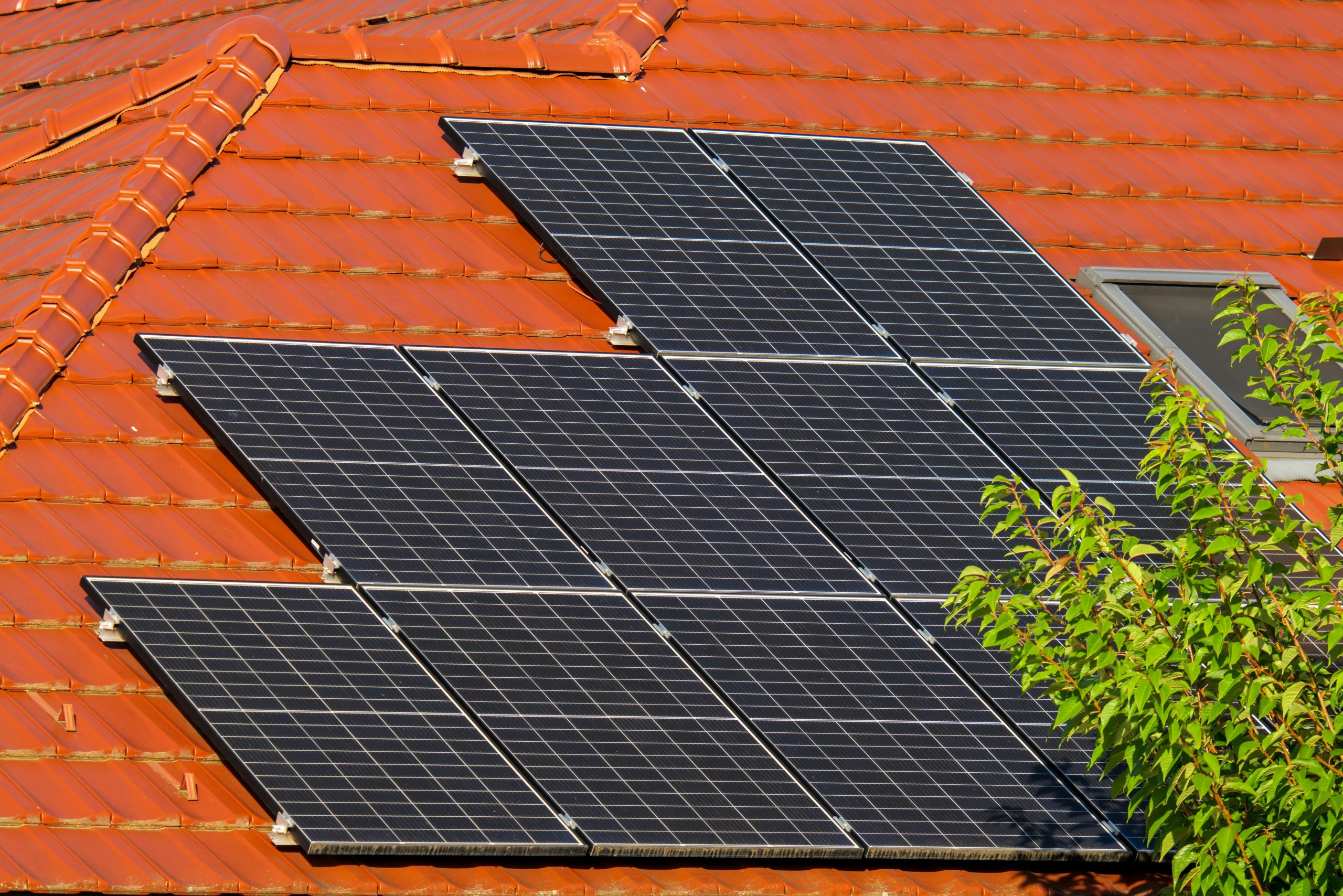 Close-up of solar panels on a red tiled roof in Croatia, highlighting renewable energy.